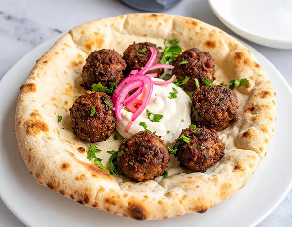 Lamb kofta with yogurt tahini and pickled onion