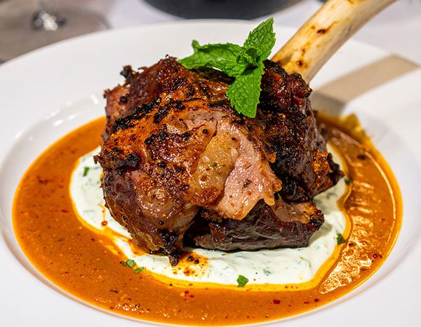 Charred lamb shoulder with harissa and mint yogurt
